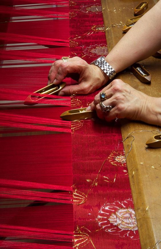 Artisan weaving at a loom